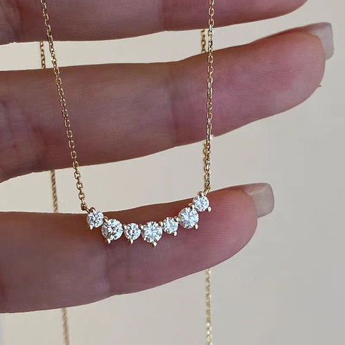 Smile curve necklace with a row of small clear stones