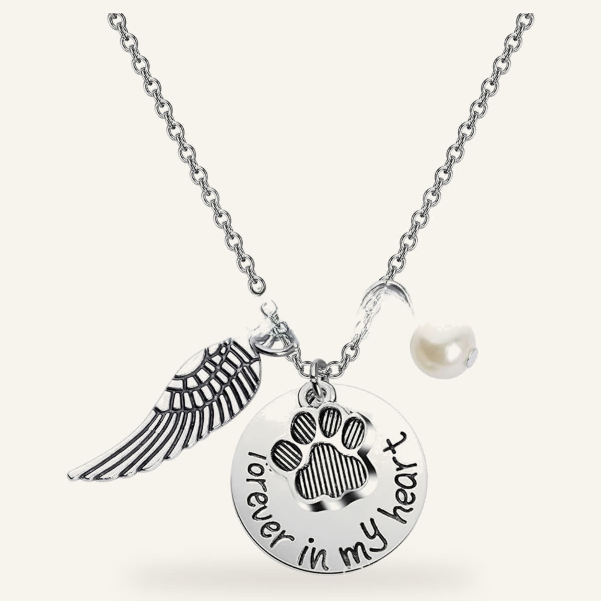 Pet memorial necklace with a paw charm, angel wing and pearl-style bead
