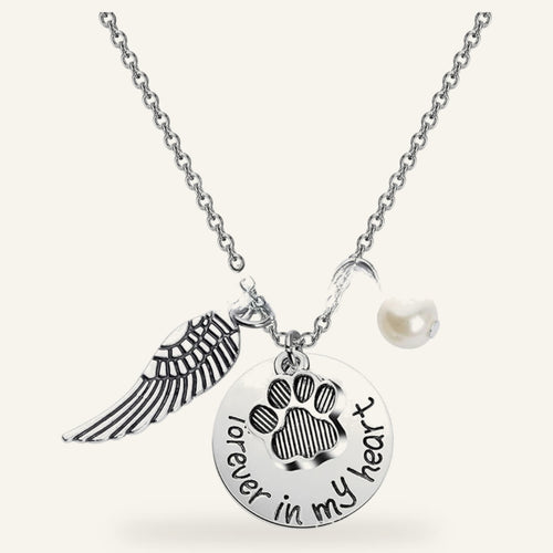 Pet memorial necklace with a paw charm, angel wing and pearl-style bead