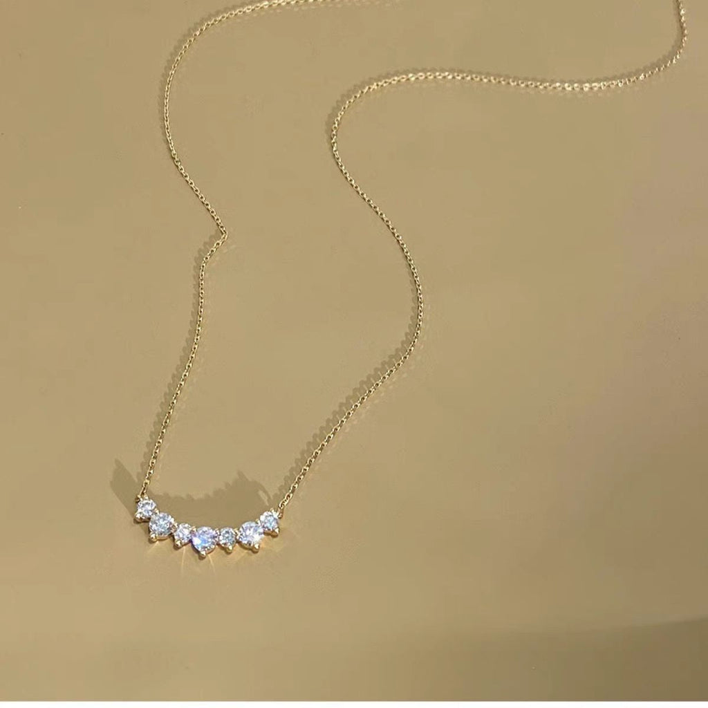 Smile curve necklace with a row of small clear stones