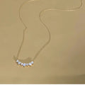 Smile curve necklace with a row of small clear stones
