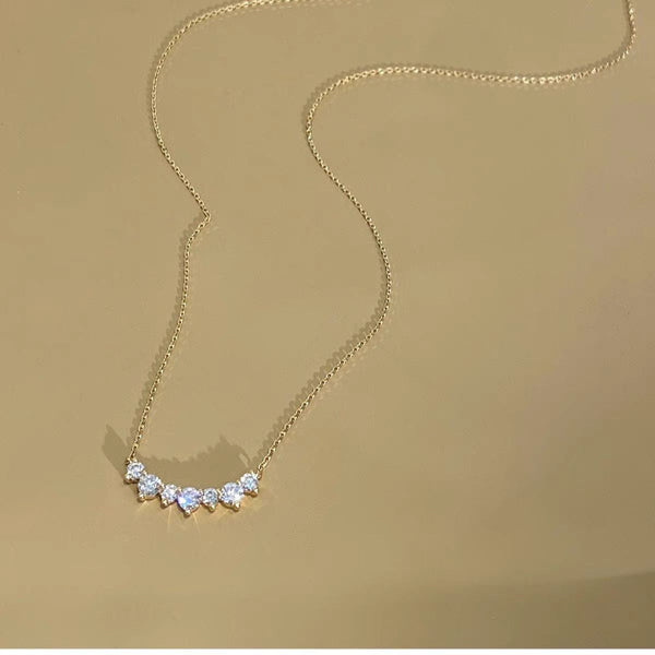 Smile curve necklace with a row of small clear stones